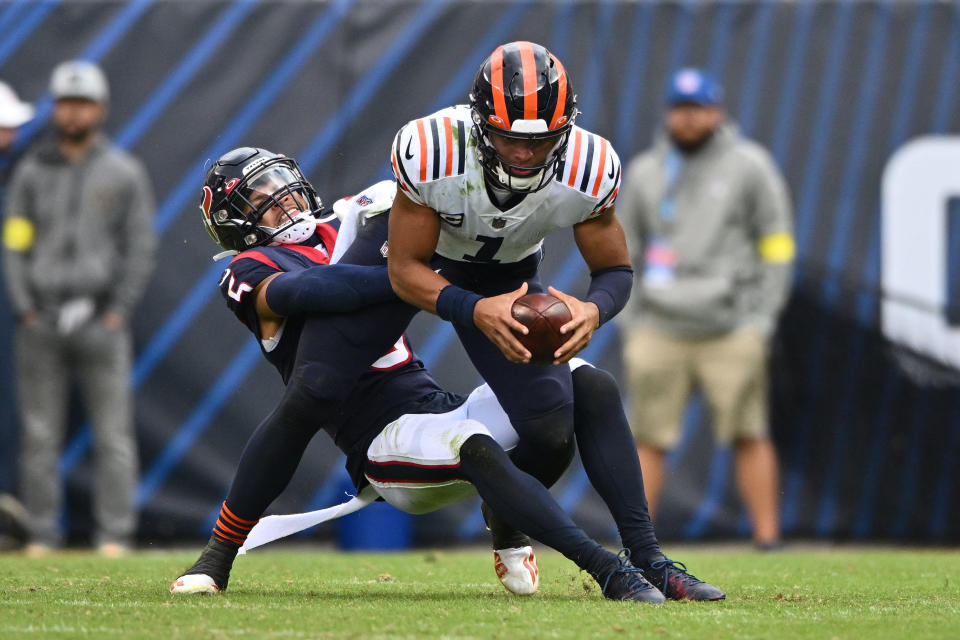 Sep 25, 2022; Chicago, Illinois, USA; Chicago Bears quarterback Justin Fields (1) is sacked for a loss in the fourth quarter by Houston Texans defensive back Jalen Pitre (5) at Soldier Field. Mandatory Credit: Jamie Sabau-USA TODAY Sports