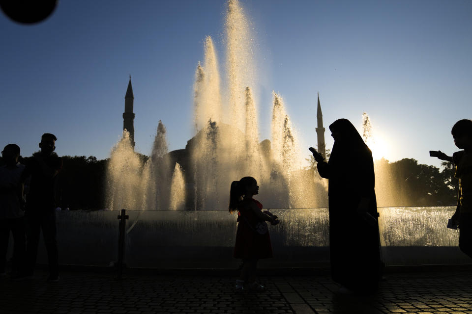 Muslims gather following the Eid al-Adha prayers, outside the iconic Haghia Sophia mosque in the historic Sultan Ahmed district of Istanbul, Wednesday, June 28, 2023. Muslims around the world celebrate Eid al-Adha by sacrificing animals to commemorate the prophet Ibrahim's faith in being willing to sacrifice his son. (AP Photo/Khalil Hamra)