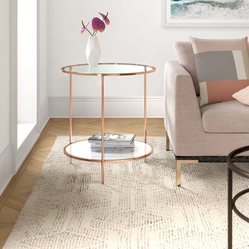 the glass end table in gold with a shelf at the bottom 