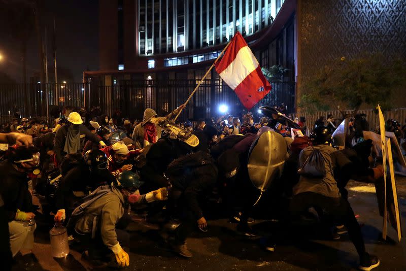 FILE PHOTO: Demonstrators clash with police during protests that led to the resignation of Peru's interim President Manuel Merino, in Lima