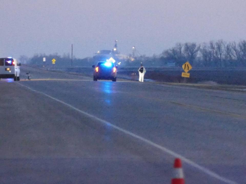 Investigators examine a crime scene south of Carman, Man. Police say five people — three of them children — were found dead Sunday morning in three incidents RCMP say are linked. (Jeff Stapleton/CBC - image credit)