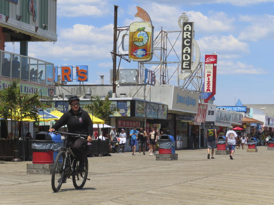 A police officer on a bicycle patrols the boardwalk in Seaside Heights, N.J., Friday, May 31, 2024. On Friday, New Jersey Attorney General Matt Platkin blamed the city of Wildwood, N.J. for not assigning enough police officers to patrol its boardwalk over the Memorial Day weekend when crowds of rowdy teens and young adults overwhelmed the city's capability to respond to disturbances, forcing the boardwalk to be shut down overnight on Sunday, May 26. (AP Photo/Wayne Parry)