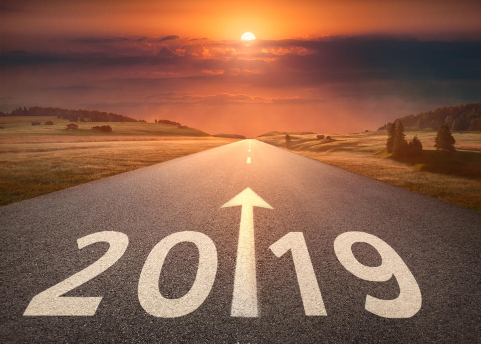 A road stretches into the distance with the year 2019 painted on it.