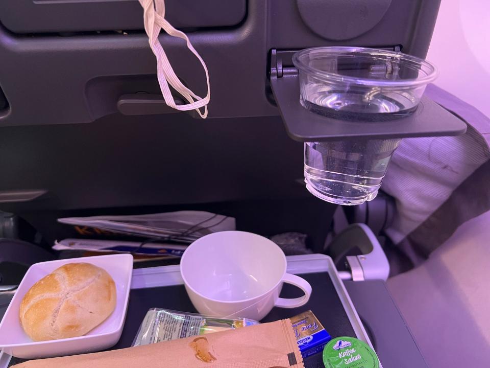 The bread and cup on my tray, with water in the cupholder.