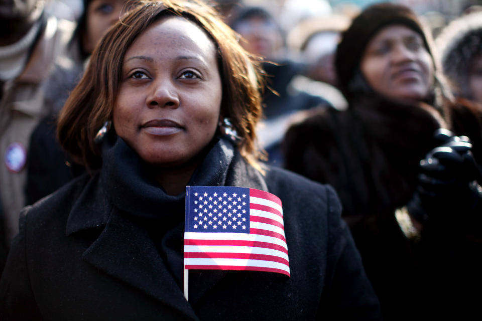 Large crowds watch the inauguration of Barack Obama as the 44th president of the United States on a large screen in the neighborhood of Harlem January 20, 2009 in New York City. (Photo by Rick Gershon/Getty Images)