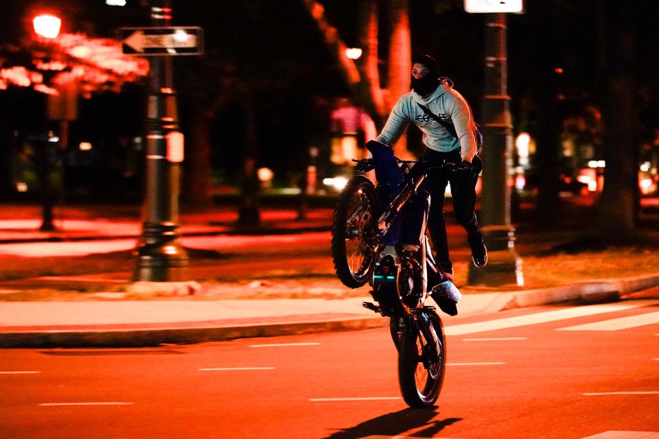 A dirt bike rides down the Benjamin Franklin Parkway in Philadelphia on June 24, 2021.