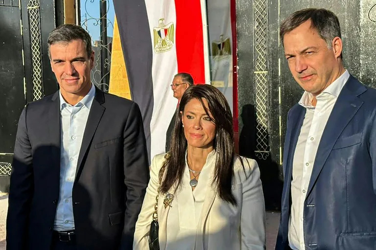 Spanish Prime Minister Pedro Sanchez (L) and his Belgian counterpart Alexander De Croo (R) visit the Rafah border crossing between Egypt and Gaza, accompanied by Egyptian International Cooperation Minister Rania al-Mashat (STR)