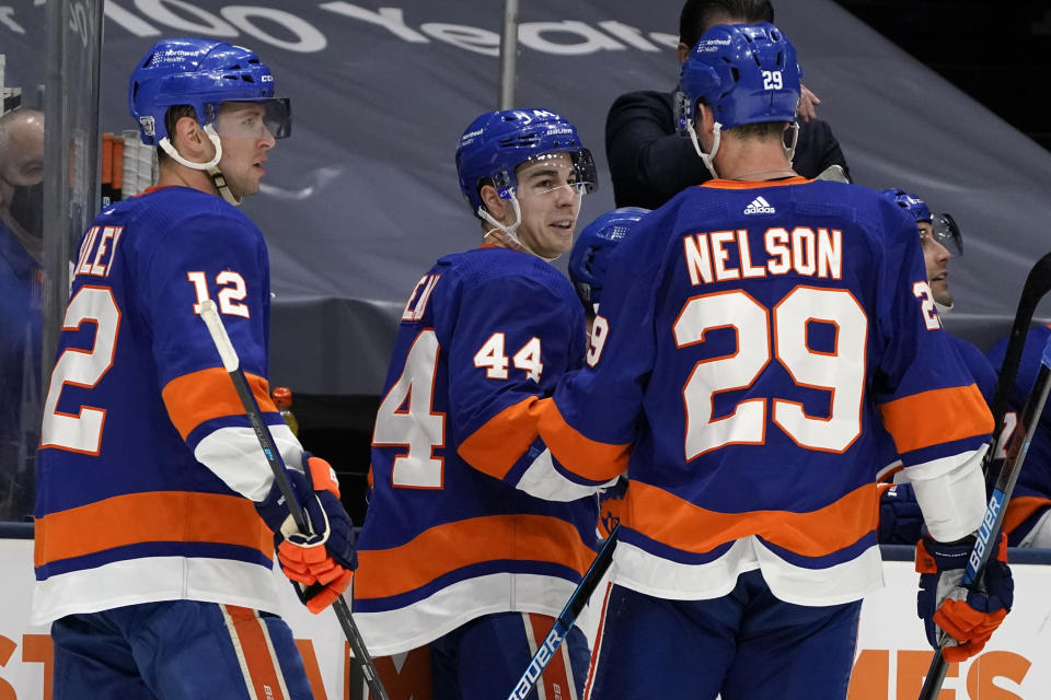 New York Islanders center Jean-Gabriel Pageau, center, celebrates with teammates Josh Bailey, left, and Brock Nelson, right, after scoring a goal against the Pittsburgh Penguins during the second period of an NHL hockey game, Sunday, Feb. 28, 2021, in Uniondale, N.Y. (AP Photo/Kathy Willens)