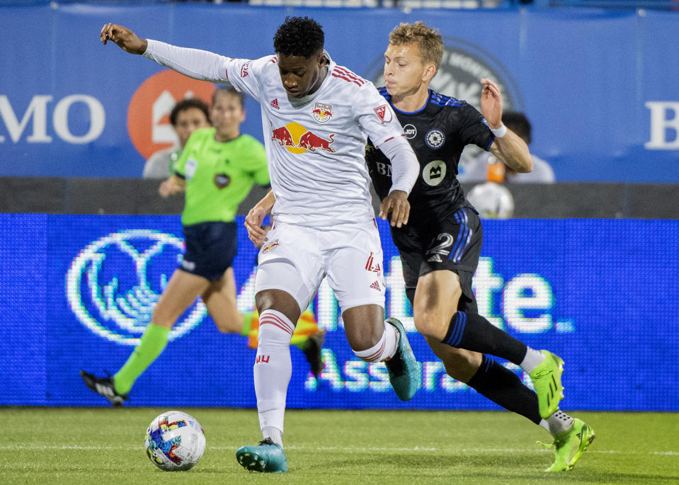 CF Montreal's Alistair Johnston, right, challenges New York Red Bulls' Andres Reyes during the first half of an MLS soccer match Wednesday, Aug. 31, 2022, in Montreal. (Graham Hughes/The Canadian Press via AP)