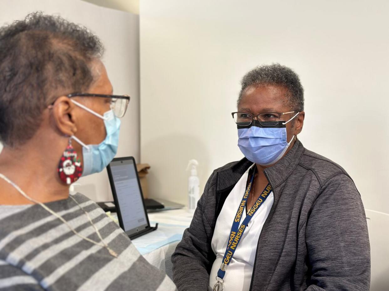 A Nova Scotia Public Health nurse prepares a patient for a COVID-19 booster shot at a Black health and wellness clinic at the Dartmouth North Community Centre on Saturday. (Taryn Grant/CBC - image credit)