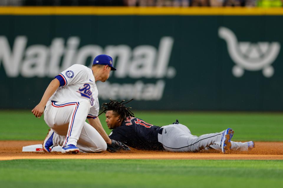 Guardians third baseman José Ramírez slides in under the tag of Rangers shortstop Corey Seager during the first inning, May 13, 2024, in Arlington, Texas.