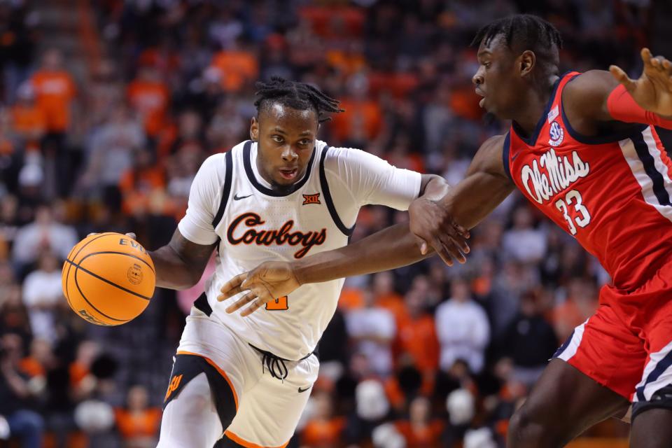 Oklahoma State guard Chris Harris Jr., left, tries to get past Ole Miss forward Josh Mballa during a game at Gallagher-Iba Arena in Stillwater on Jan. 28. Oklahoma State won 82-60.