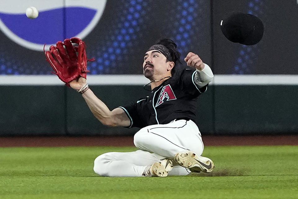 Arizona Diamondbacks' Corbin Carroll fields a fly-out hit by San Diego Padres' Jackson Merrill during the second inning of a baseball game, Saturday, May 4, 2024, in Phoenix. (AP Photo/Matt York)