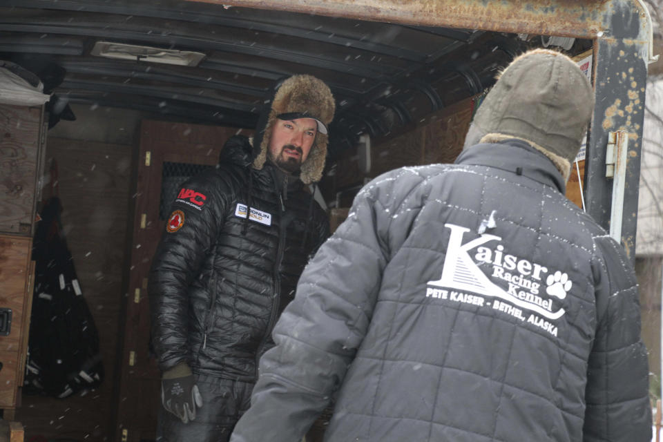 Defending Iditarod Trail Sled Dog Race champion Pete Kaiser, left, talks to a handler on his team before the ceremonial start of the Iditarod Trail Sled Dog Race Saturday, March 7, 2020, in Anchorage, Alaska. The real race starts March 8 about 50 miles north of Anchorage, with the winner expected in the Bering Sea coastal town of Nome about 10 or 11 days later. (AP Photo/Mark Thiessen)