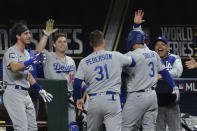 Los Angeles Dodgers' Chris Taylor celebrates at the dugout after scoring on a single by Corey Seager during the eighth inning in Game 4 of the baseball World Series against the Tampa Bay Rays Saturday, Oct. 24, 2020, in Arlington, Texas. (AP Photo/Tony Gutierrez)