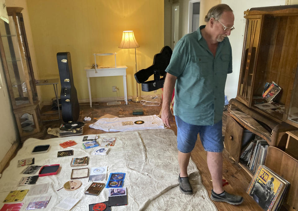 Mike Ford, whose home was flooded by Hurricane Ian, stands inside his residence in Fort Myers, Fla., Sunday, Oct. 9, 2022. Southwest Florida is getting some advice from the Florida Panhandle, which was struck by Hurricane Michael in 2018, as it moves ahead following Ian. (AP Photo/Jay Reeves)