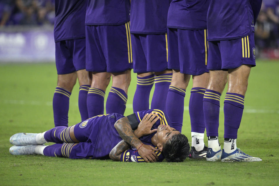 Orlando City midfielder Facundo Torres lies behind the line to protect against a low penalty kick by the New York Red Bulls during the first half of an MLS soccer match Saturday, Feb. 25, 2023, in Orlando, Fla. (AP Photo/Phelan M. Ebenhack)