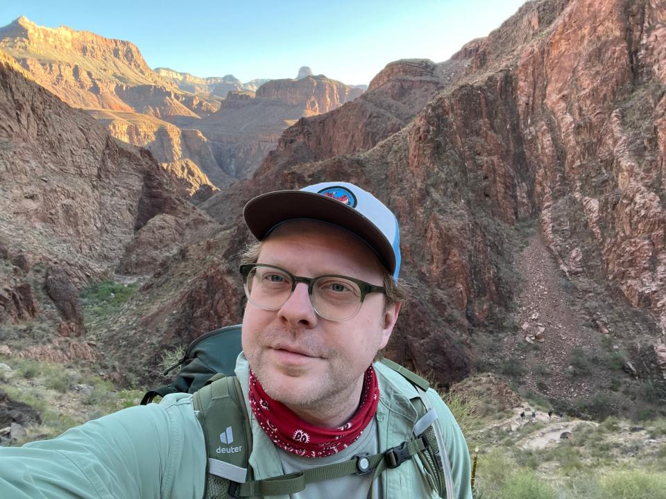 A man taking a selfie while hiking in the Grand Canyon