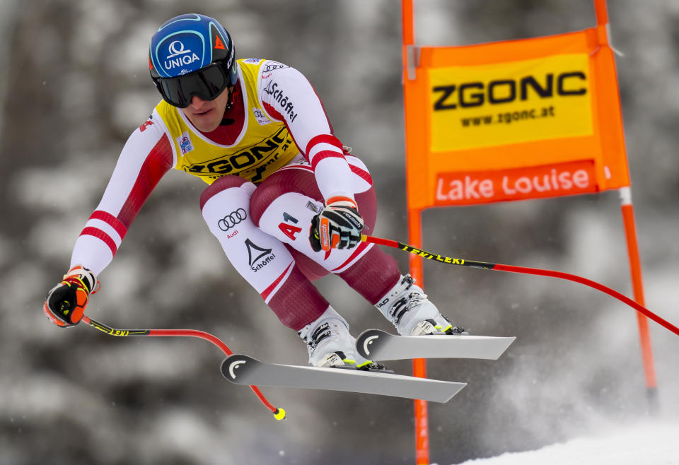 Matthias Mayer, of Austria, blasts down the course on his way to winning the men's World Cup downhill ski race in Lake Louise, Alberta, Saturday, Nov. 27, 2021. (Frank Gunn/The Canadian Press via AP)