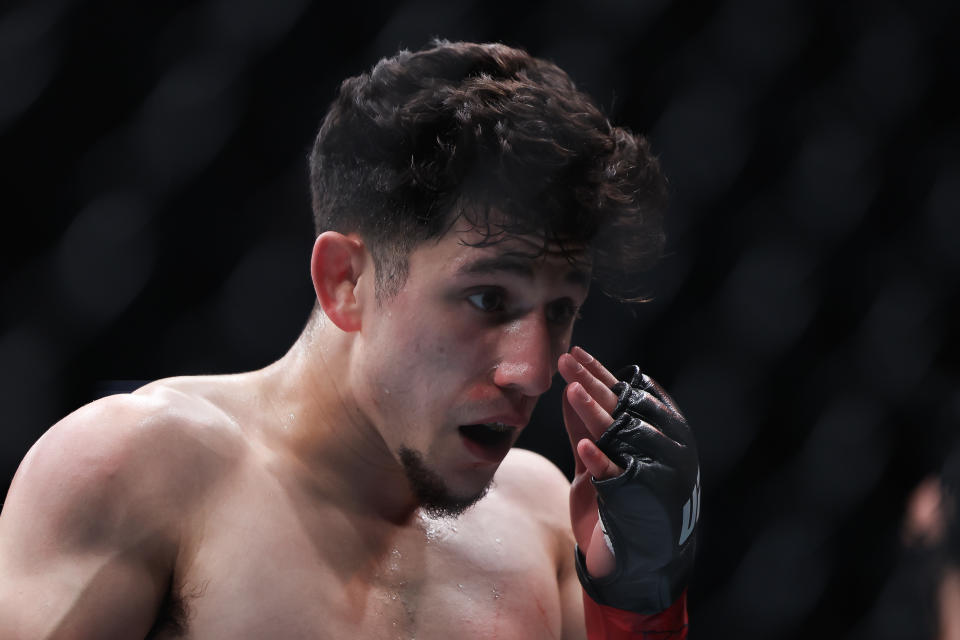 NEWARK, NEW JERSEY - JUNE 01: Mitch Raposo holds his eye against Andre Lima of Brazil their flyweight bout during UFC 302 at Prudential Center on June 01, 2024 in Newark, New Jersey. (Photo by Luke Hales/Getty Images)