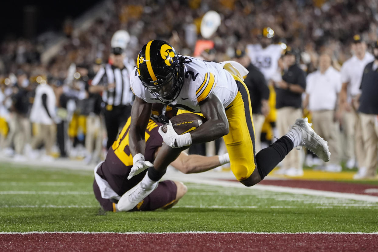 Iowa running back Kaleb Johnson (2) scores a 40-yard rushing touchdown during the second half of an NCAA college football game against Minnesota, Saturday, Sept. 21, 2024, in Minneapolis. (AP Photo/Abbie Parr)