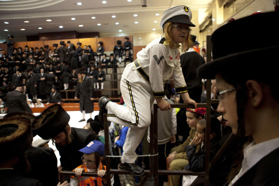 An ultra-Orthodox Jewish boy wears a costume while celebrating the Purim festival at a synagogue in the town of Bnei Brak near Tel Aviv, Israel, late Sunday, Feb. 24, 2013.  (AP Photo/Ariel Schalit)