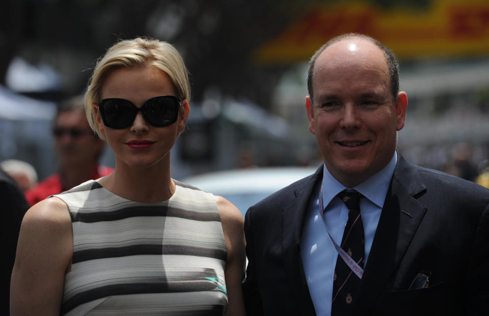 Prince Albert of Monaco and Princess Charlene (L) stand prior racing at the Circuit de Monaco on May 27, 2012 in Monte Carlo during the Monaco Formula One Grand Prix. AFP PHOTO / DIMITAR DILKOFFDIMITAR DILKOFF/AFP/GettyImages
