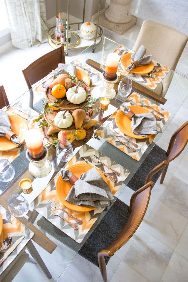 <p>Perfect for those with a time crunch, simply display an assortment of mini pumpkins and pears on a tiered serving tray. Weave in patterned placemats and fun silverware to make your holiday table stand out. </p><p><em><a href="https://designimprovised.com/2016/10/harvest-themed-fall-dining-room-decor.html" rel="nofollow noopener" target="_blank" data-ylk="slk:Get the tutorial at Design Improvised »;elm:context_link;itc:0;sec:content-canvas" class="link ">Get the tutorial at Design Improvised »</a></em></p>