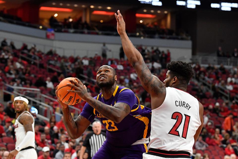 Lipscomb center Ahsan Asadullah (23) attempts a shot over Louisville forward Sydney Curry (21) during the first half of an NCAA college basketball game in Louisville, Ky., Tuesday, Dec. 20, 2022. (AP Photo/Timothy D. Easley)