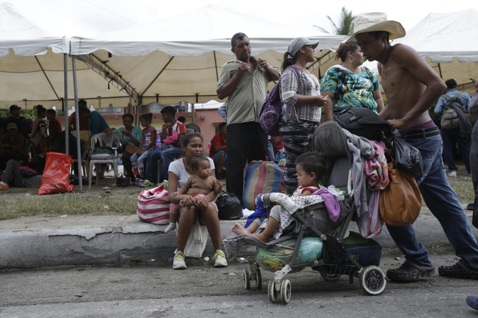 A Honduran migrant bound for the U.S. border pushes a baby carriage in Zacapa, Guatemala, Wednesday, Oct. 17, 2018. The group of some 2,000 Honduran migrants hit the road in Guatemala again Wednesday, hoping to reach the United States despite President Donald Trump's threat to cut off aid to Central American countries that don't stop them. (AP Photo/Moises Castillo)