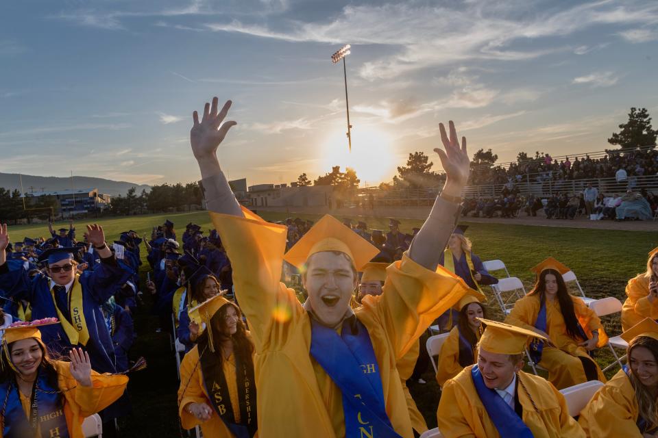 Thomas Eberhardt cheers during a stadium wave at Serrano High School's Graduation Ceremony in Phelan CA on Thursday June 8, 2023. Technical difficulties delayed the ceremony, and viistors and graduates filled the delay with cheering waves across the stadium.  (James Quigg, for the Daily Press)