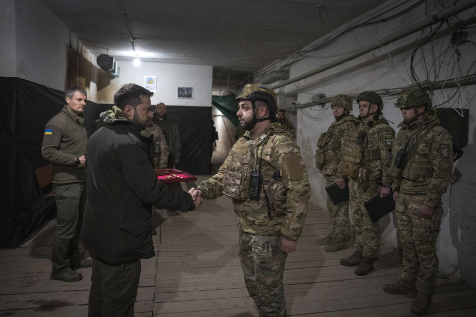 Ukrainian President Volodymyr Zelenskyy awards servicemen during his visit to the front-line city of Kupiansk, Kharkiv region, Ukraine, Thursday, Nov. 30, 2023. (AP Photo/Efrem Lukatsky)