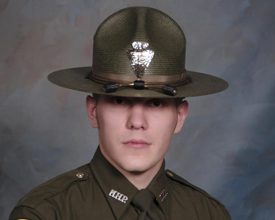 REMOVES REFERENCE TO BOOKING PHOTO - This undated photo provided by the Montana Highway Patrol shows Montana Highway Patrol Trooper Wade Palmer. Authorities say Palmer was in critical condition after being shot while investigating an earlier shooting in Missoula. Highway Patrol officials said in a statement Friday, March 15, 2019, another trooper found the wounded 35-year-old Palmer in his patrol car outside a bar in Evaro, Mont. The wife of trooper Palmer, who is now recovering from a traumatic brain injury after being shot three times, is thanking the medical team who gave them "the fighting chance we needed to get through this." Lindsey Palmer made her emotional comments Wednesday, May 22, 2019, at the University of Utah Health in Salt Lake City shortly before her husband was to be released from the hospital and flown back home. (Montana Highway Patrol via AP, File)