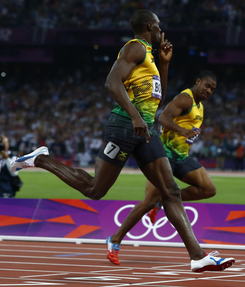 Jamaica's Usain Bolt celebrates as he crosses the finish line to win the men's 200m final ahead of compatriot Yohan Blake (R) during the London 2012 Olympic Games at the Olympic Stadium August 9, 2012. REUTERS/Eddie Keogh (BRITAIN - Tags: OLYMPICS SPORT ATHLETICS) 