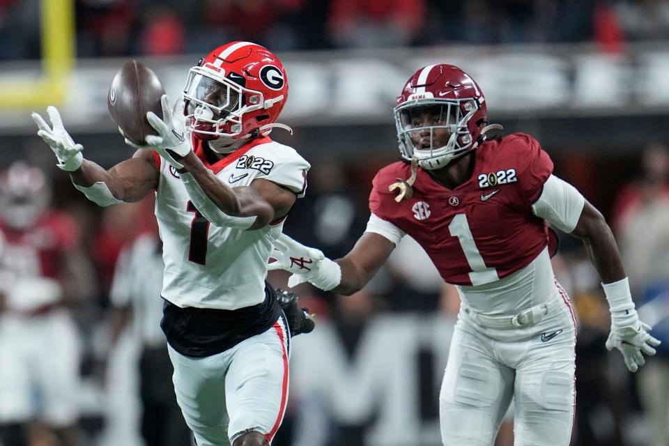 Georgia's George Pickens catches a pass in front of Alabama's Kool-Aid McKinstry during the first half of the College Football Playoff championship football game. Monday, Jan. 10, 2022, in Indianapolis.