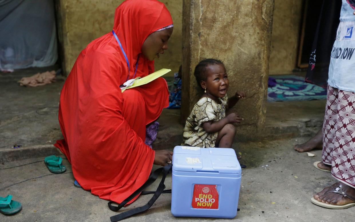 A child cries after she was administered with a polio vaccine during a house to house vaccination exercise in Maiduguri, Nigeria - Sunday Alamba/AP