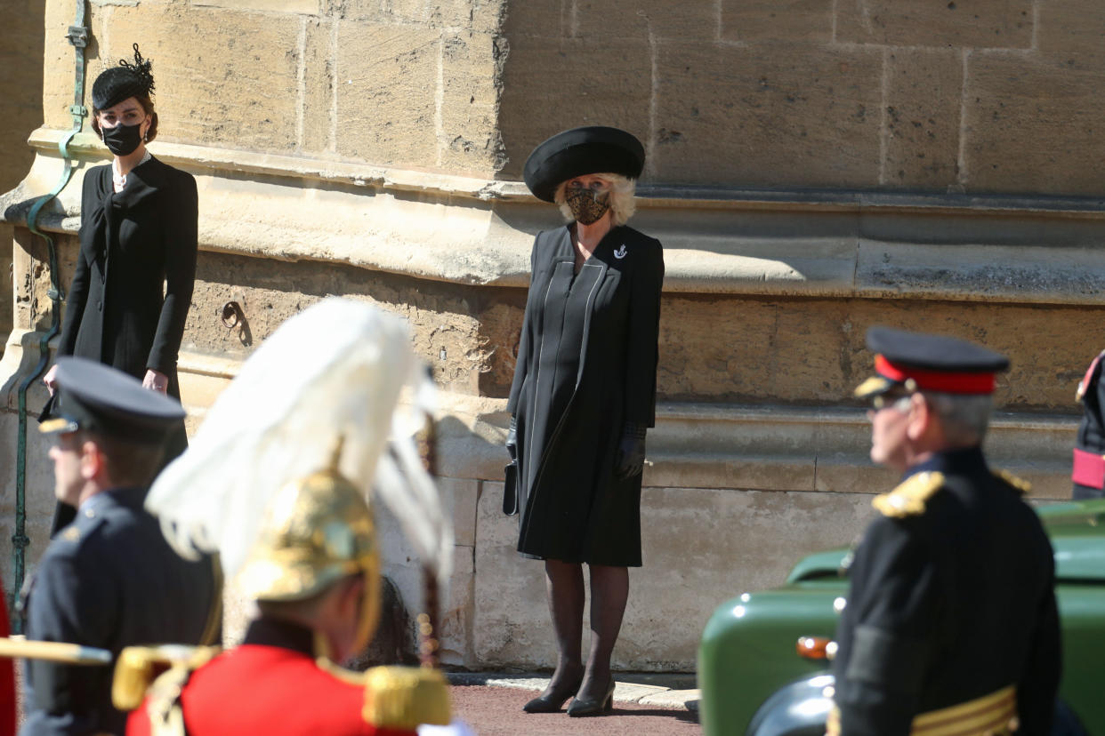 WINDSOR, ENGLAND - APRIL 17: The Duchess of Cambridge (L) and the Duchess of Cornwall watch the procession at the Galilee Porch at St George's Chapel during the funeral of Prince Philip, Duke of Edinburgh, at Windsor Castle on April 17, 2021 in Windsor, England. Prince Philip of Greece and Denmark was born 10 June 1921, in Greece. He served in the British Royal Navy and fought in WWII. He married the then Princess Elizabeth on 20 November 1947 and was created Duke of Edinburgh, Earl of Merioneth, and Baron Greenwich by King VI. He served as Prince Consort to Queen Elizabeth II until his death on April 9 2021, months short of his 100th birthday. His funeral takes place today at Windsor Castle with only 30 guests invited due to Coronavirus pandemic restrictions. (Photo by Steve Parsons - WPA Pool/Getty Images)