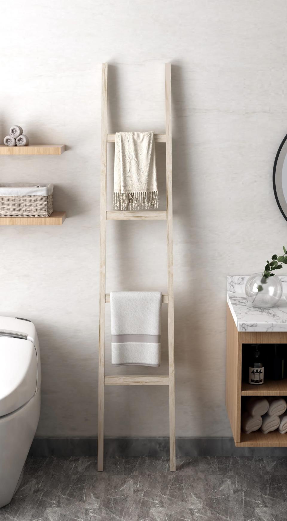 leaning blanket ladder in a bathroom with towels on it
