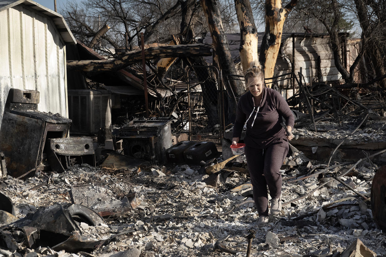 A homeowner searches for items in the remains of her house after it was destroyed by the Smokehouse Creek fire near Stinnett, Texas, on March 3, 2024. / Credit: Scott Olson/Getty Image
