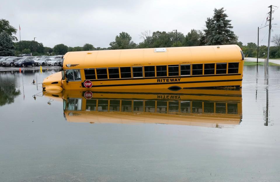 A school bus is partially submerged in flood water near Pilgrim Park Middle School on Pilgrim Parkway in Elm Grove on Monday, Sept. 12, 2022. A slow moving storm dumped more than a month’s worth of rain on southeast Wisconsin on Sunday and early Monday, leading to flooding across the region.