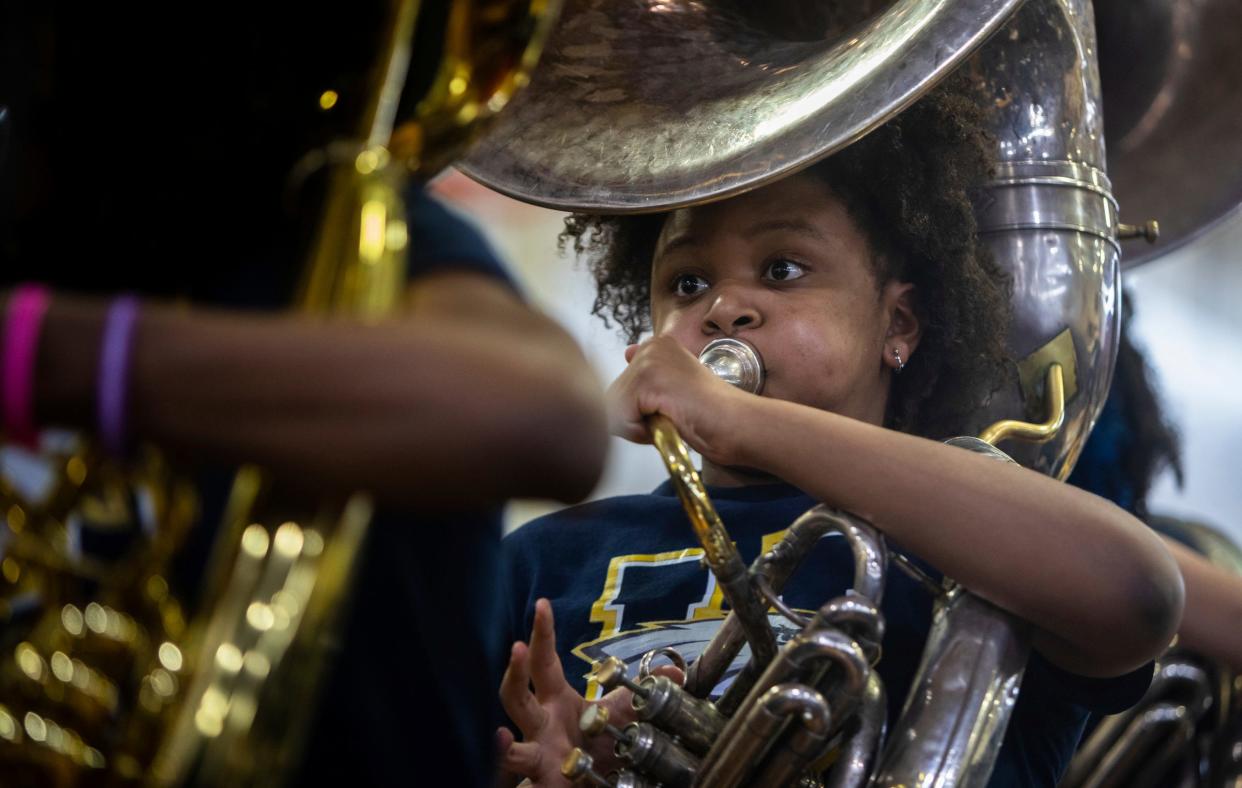 A University High School Academy band member performs in front of a large crowd during the 8th annual Harvest Festival in Detroit on Wednesday, Nov. 22, 2023.