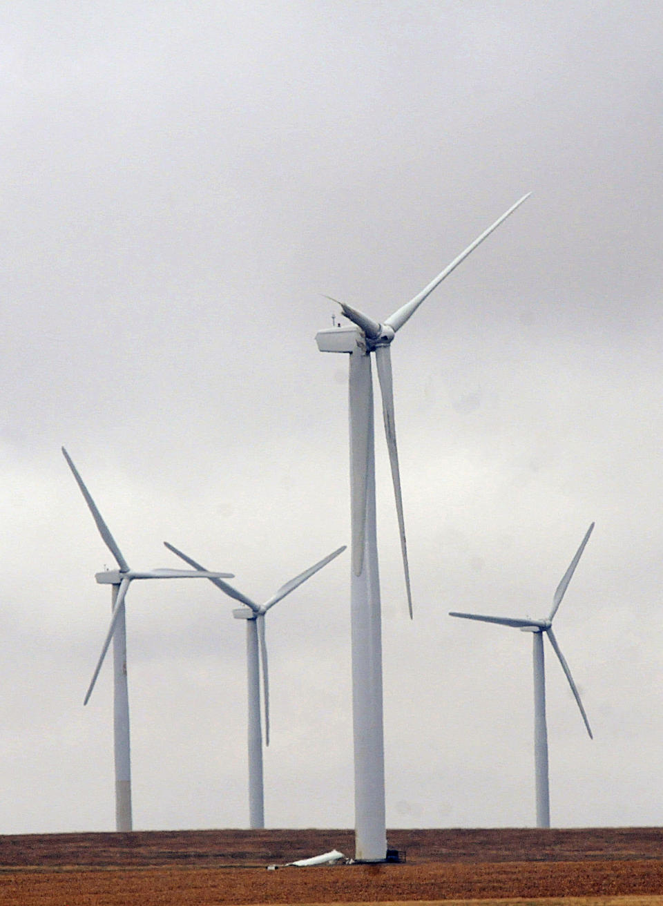 A section of the broken blade rests below a 300-foot wind turbine Tuesday, April 29, 2014, south of Highmore, S.D., where single-engine Piper crashed in foggy weather Sunday evening April 27, 2014, killing the pilot and three cattlemen. A National Transportation Safety Board investigator is trying to determine why the airplane was flying so low when it apparently hit the blade of the wind turbine. The wreckage will be removed by Wednesday from the site and taken to Colorado. (AP Photo/Capital Journal, Joel Ebert)