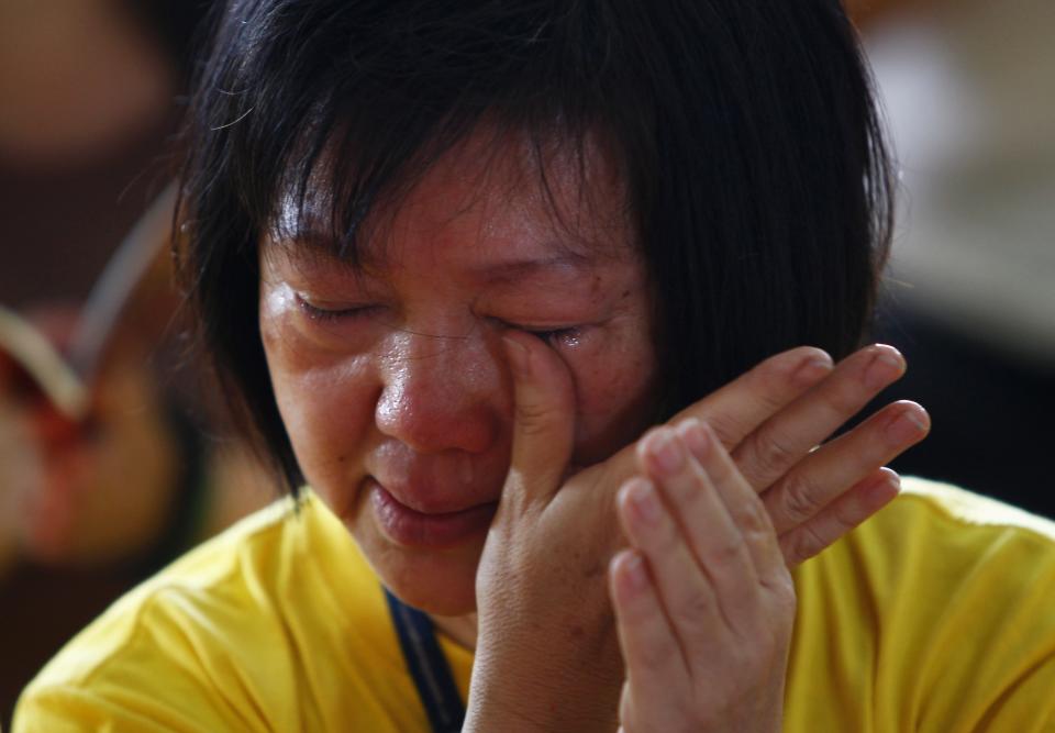 A women cries during special prayer session for family members of passengers onboard missing Malaysia Airlines flight MH370 in Buddhist temple in Subang Jaya