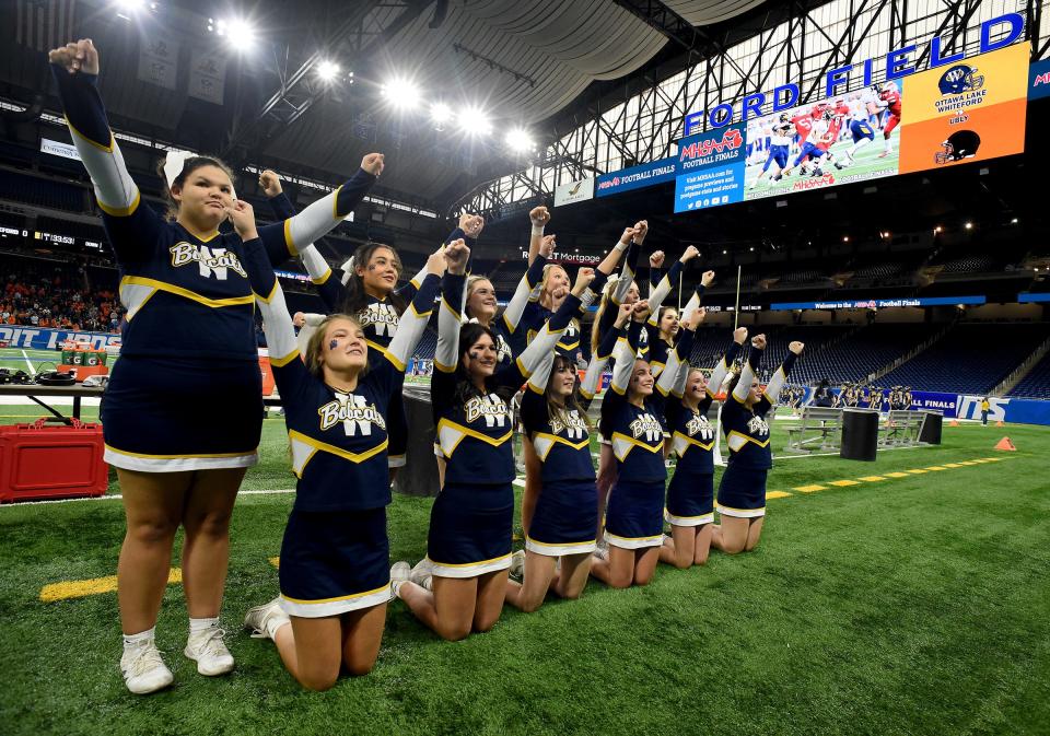 The Whiteford cheerleaders warming up at the Division 8 State Championships at Ford Field Friday.