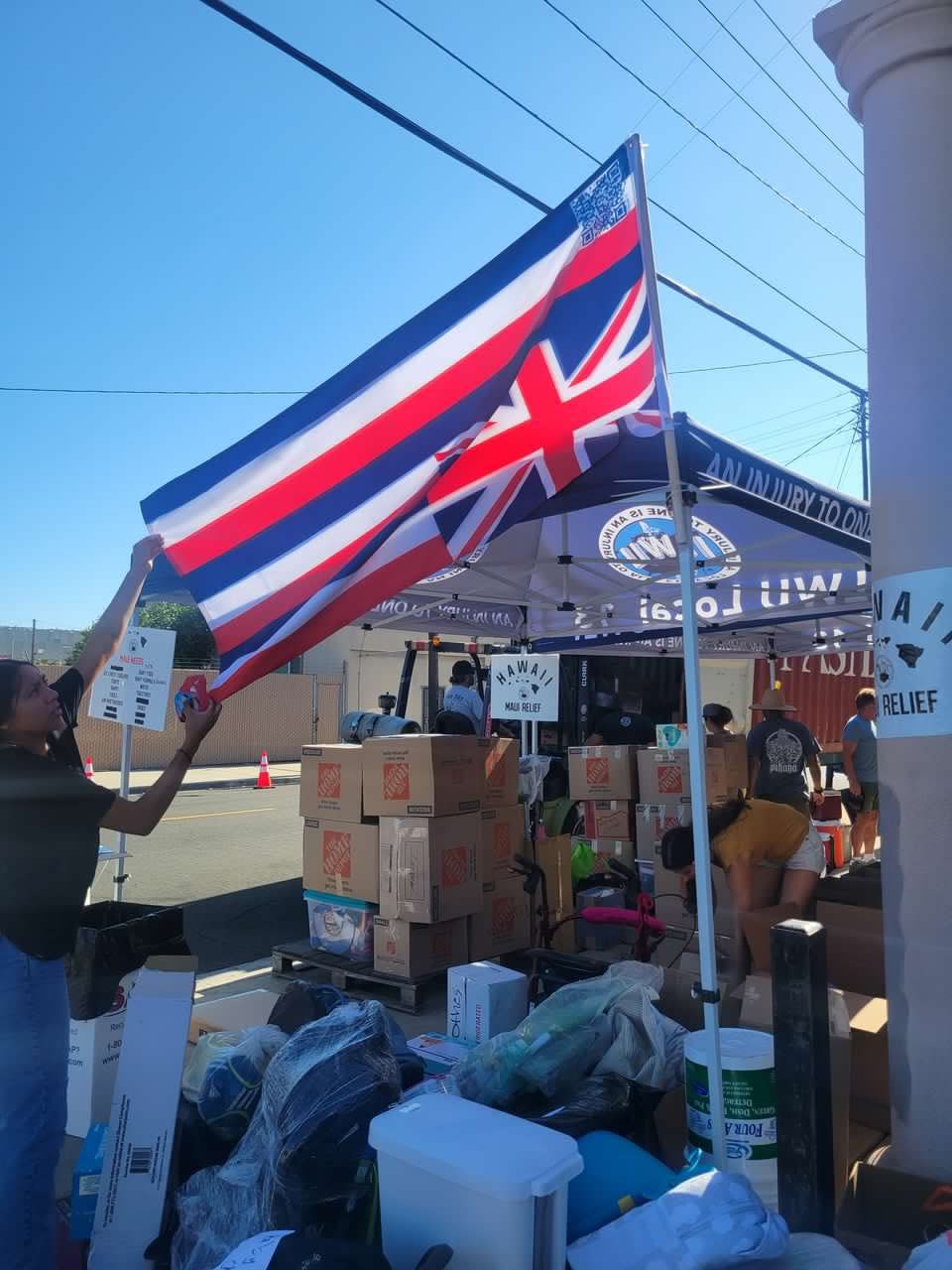 Maui native Ashlyn Hi'ilei Ani helps set up a Maui wildfire recovery donation site in Long Beach, Calif., just days after the Aug. 8 fire killed at least 115 people. Ani has returned to Maui to help her family and volunteer with relief efforts.