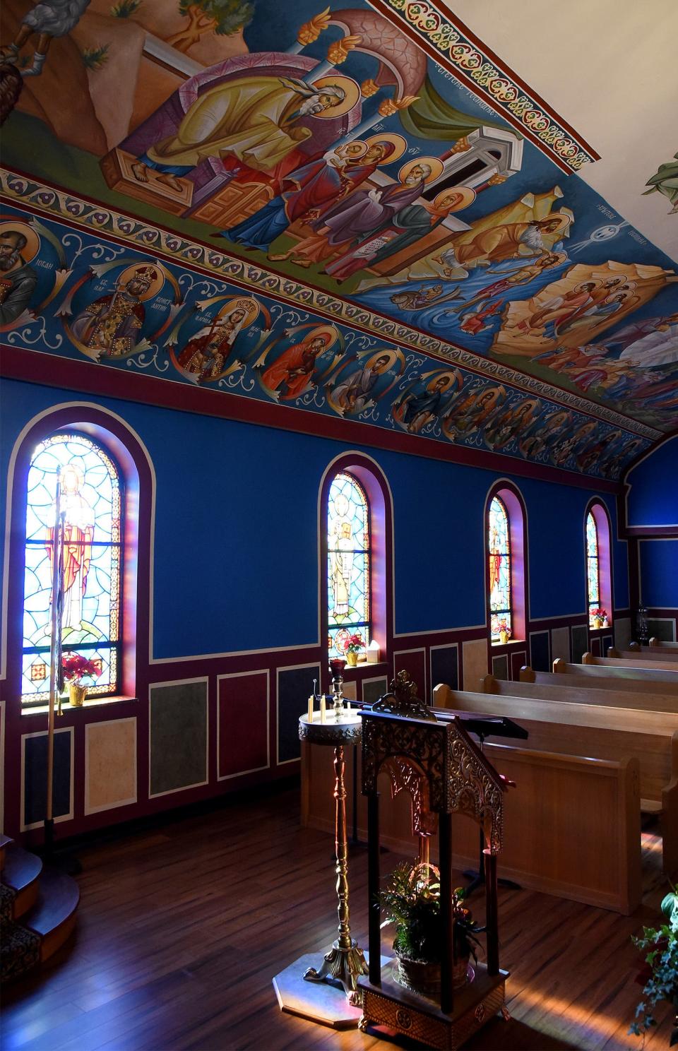 The "Serbian Blue" walls and the brightly colored icons are shown at St. George Serbian Orthodox Church.