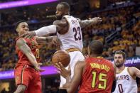 Atlanta Hawks guard Jeff Teague (0) passes to center Al Horford (15) as Cleveland Cavaliers forward LeBron James (23) defends during the second half in game one of the second round of the NBA Playoffs at Quicken Loans Arena. The Cavs won 104-93. Mandatory Credit: Ken Blaze-USA TODAY Sports