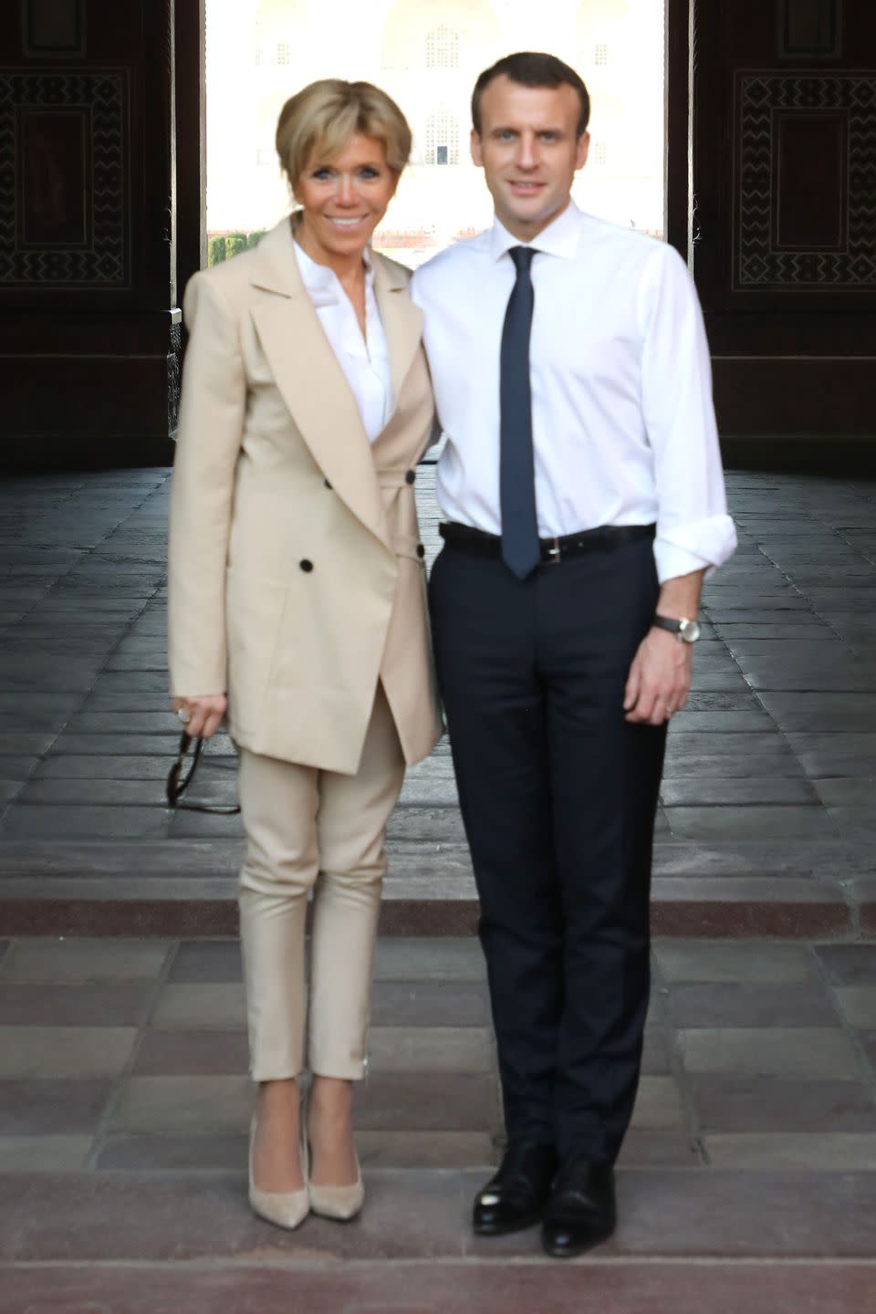 <p>With President Macron at the Taj Mahal in the Indian city of Agra wearing an oversized tan jacket, matching skinny pants, and pumps.</p>