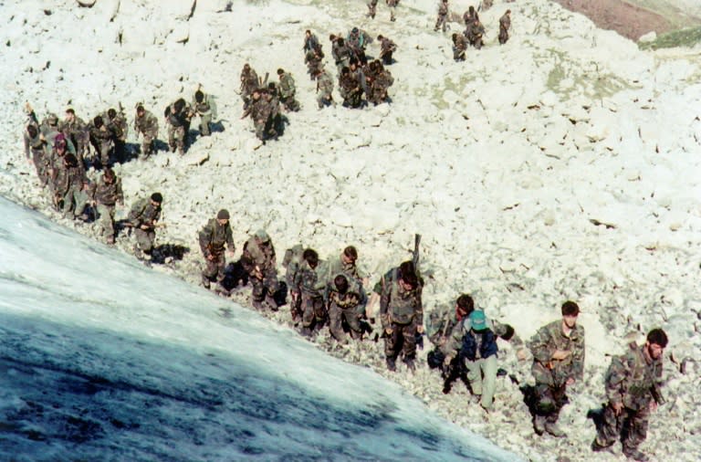 Bosnian army troops are seen walking up a hill near the city of Visoko, in 1995