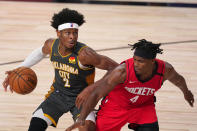 Oklahoma City Thunder's Shai Gilgeous-Alexander (2) handles the ball as Houston Rockets' Danuel House Jr. (4) defends during the second half of an NBA first-round playoff basketball game, Monday, Aug. 31, 2020, in Lake Buena Vista, Fla. (AP Photo/Mark J. Terrill)